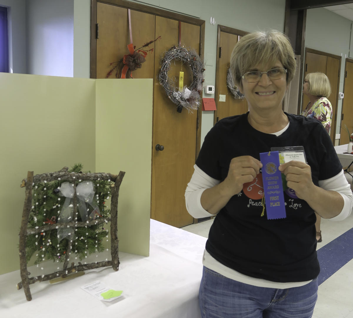 Lynne Damizzi with her ribbons for her winning design